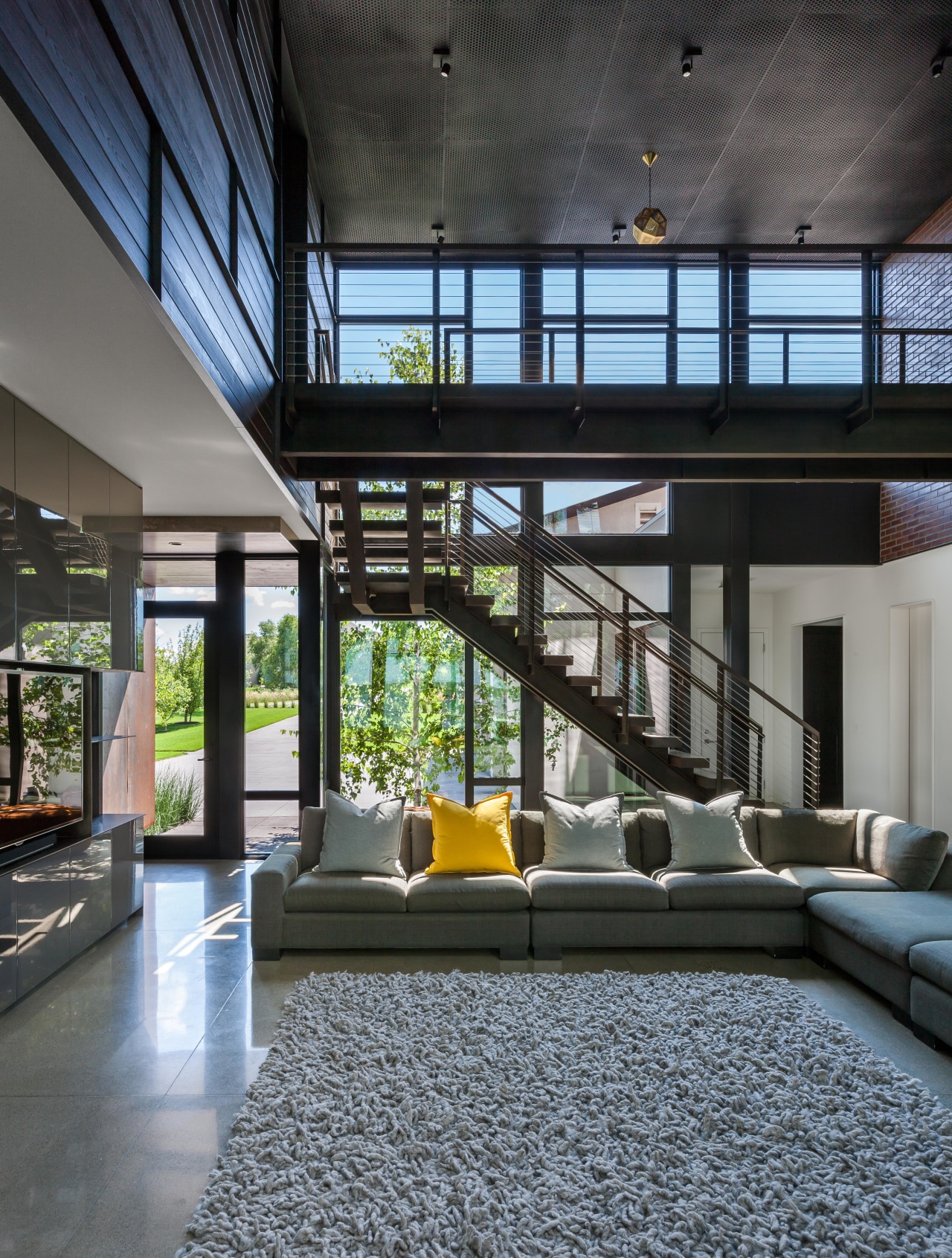 ​​​​​​​The living area in this family home is home, house, interior design, living room, furniture, light, industrial, Altus Architecture