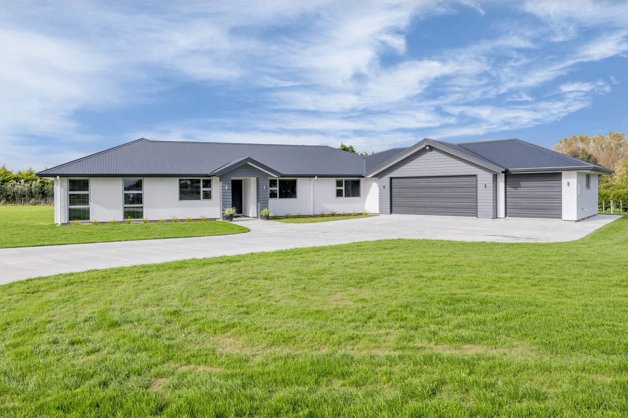 Long, light-filled and cleverly laid out, this classic-meets-modern cottage, elevation, estate, facade, farmhouse, grass, home, house, land lot, landscape, property, real estate, residential area, siding, yard, green, white