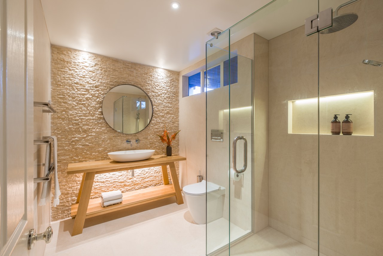 In this powder room, designer Natalie Du Bois bathroom, home, interior design, real estate, room, brown, gray