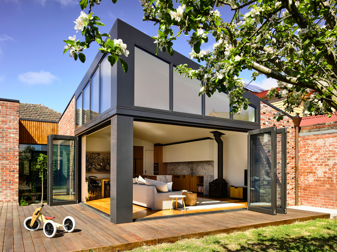 To match the existing home’s cladding, recycled clinker architecture, backyard, home, house, property, residential area, brick extension, renovation, deck, extension, bifold windows, porter architects