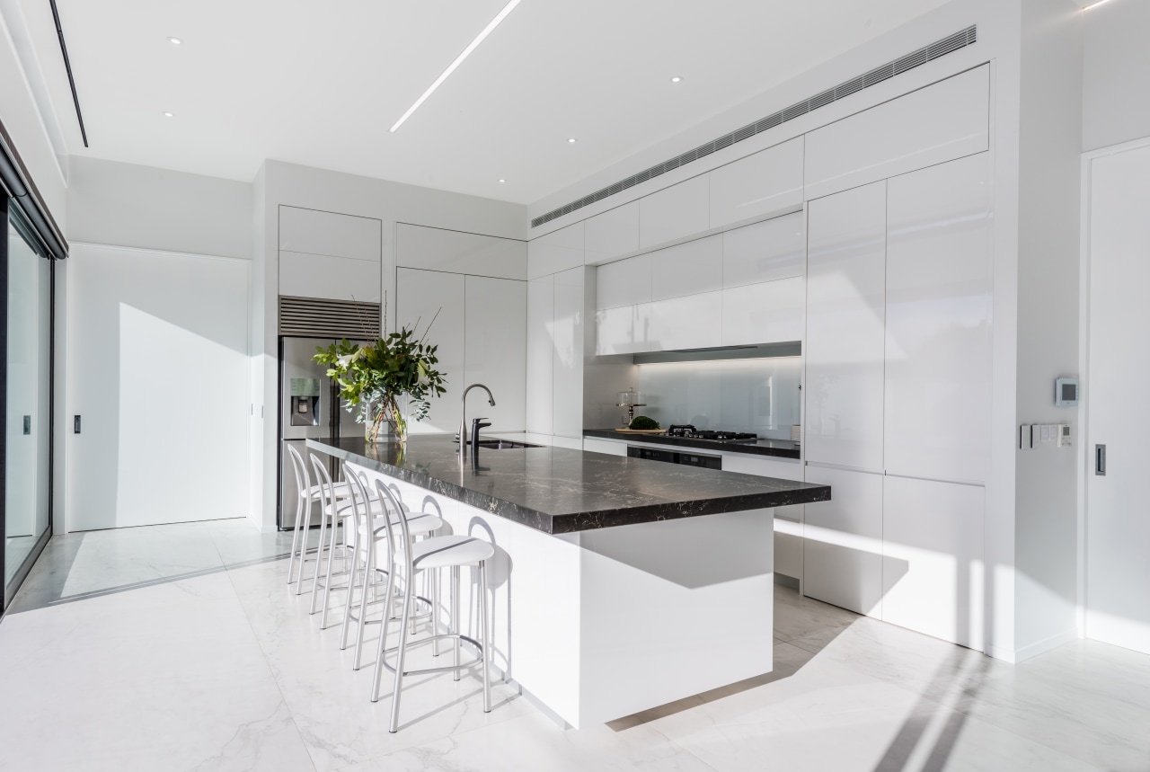 ​​​​​​​The fridge is set to the side of architecture, countertop, benchtop, interior design, kitchen, white cabinetry,  Ceasarstone, Island, Emma Morris, Eterno Design