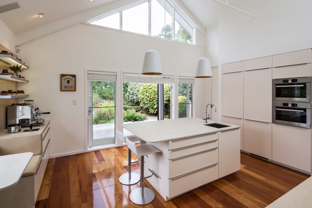 A new light-toned kitchen sits in a light-filled architecture, benchtop, interior design, kitchen, Damien Hannah, German Kitchens, white, timber floor