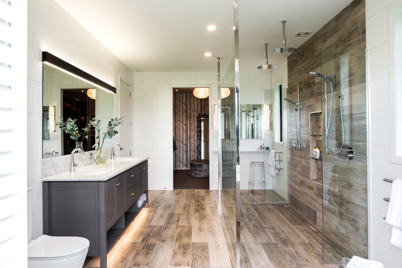 ​​​​​​​A dressing room accessed by both the master bathroom, building, ceiling, door, estate, floor, flooring, furniture, hardwood, home, house, interior design, loft, property, real estate, room, tile, wood flooring, white, gray