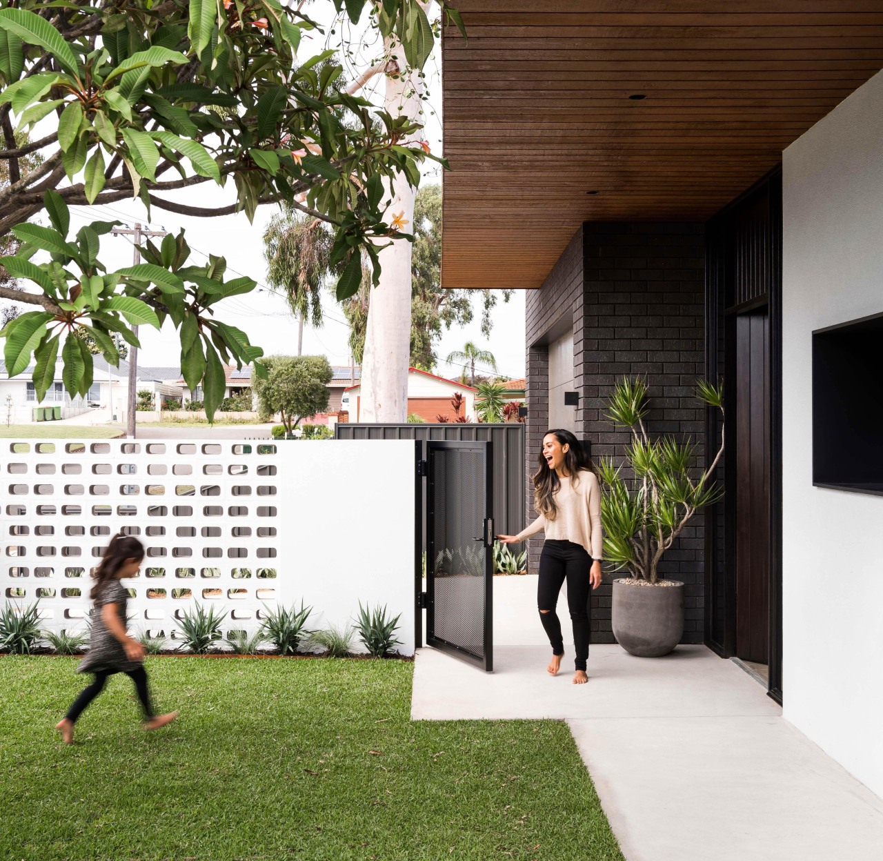 ​​​​​​​Timber cladding wraps round and under the overhanging architecture, artificial turf, courtyard, facade, grass, home, house, lawn, plant, Dalecki Design