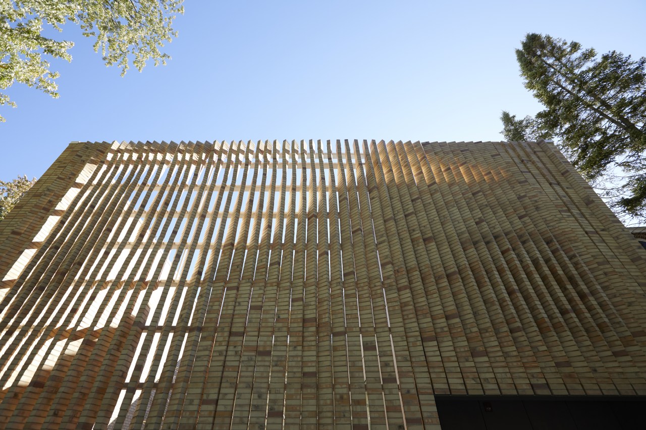 ​​​​​​​Twisting brick columns on the front facade of architecture, building, facade, house, reinforced concrete, sky, tree, brown, teal