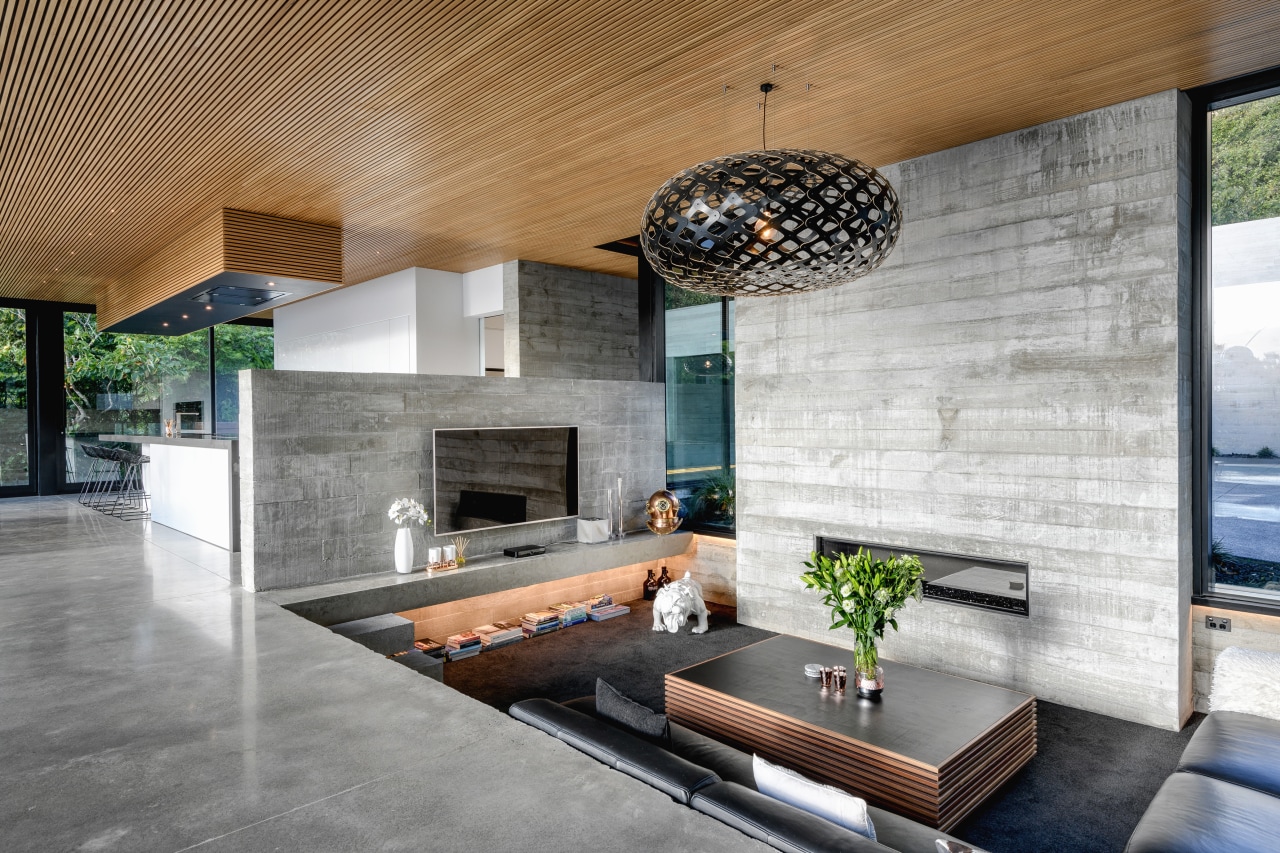 ​​​​​​​The home’s tilt slab concrete walls have a architecture, building, ceiling, concrete, design, floor, flooring, furniture, home, house, interior design, living room, lobby, property, real estate, room, table, tile, wall, gray