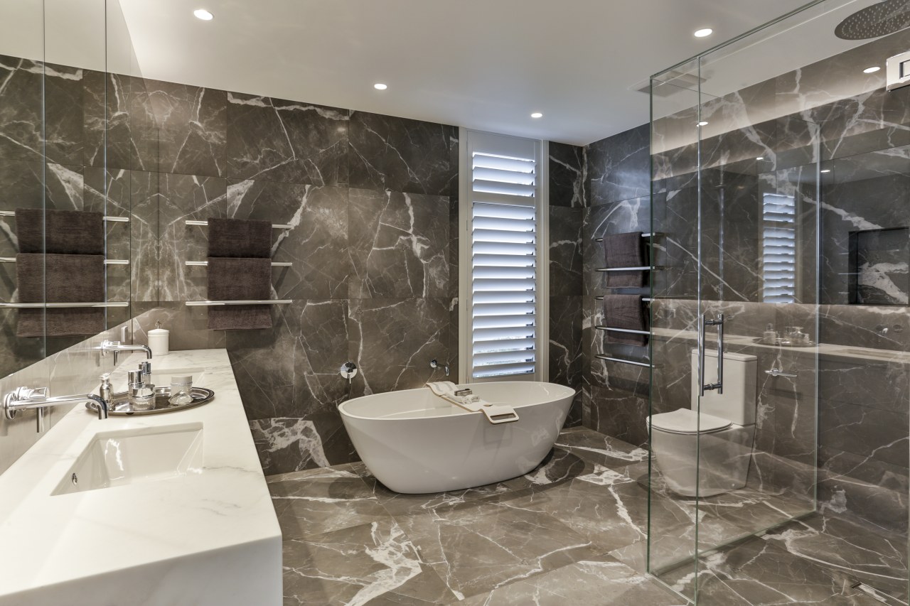 ​​​​​​​Large format porcelain tiles in a luxurious veined architecture, bathroom, bathtub, black-and-white, building, ceiling, floor, flooring, home, house, interior design, marble, plumbing fixture, property, real estate, room, tile, wall, gray