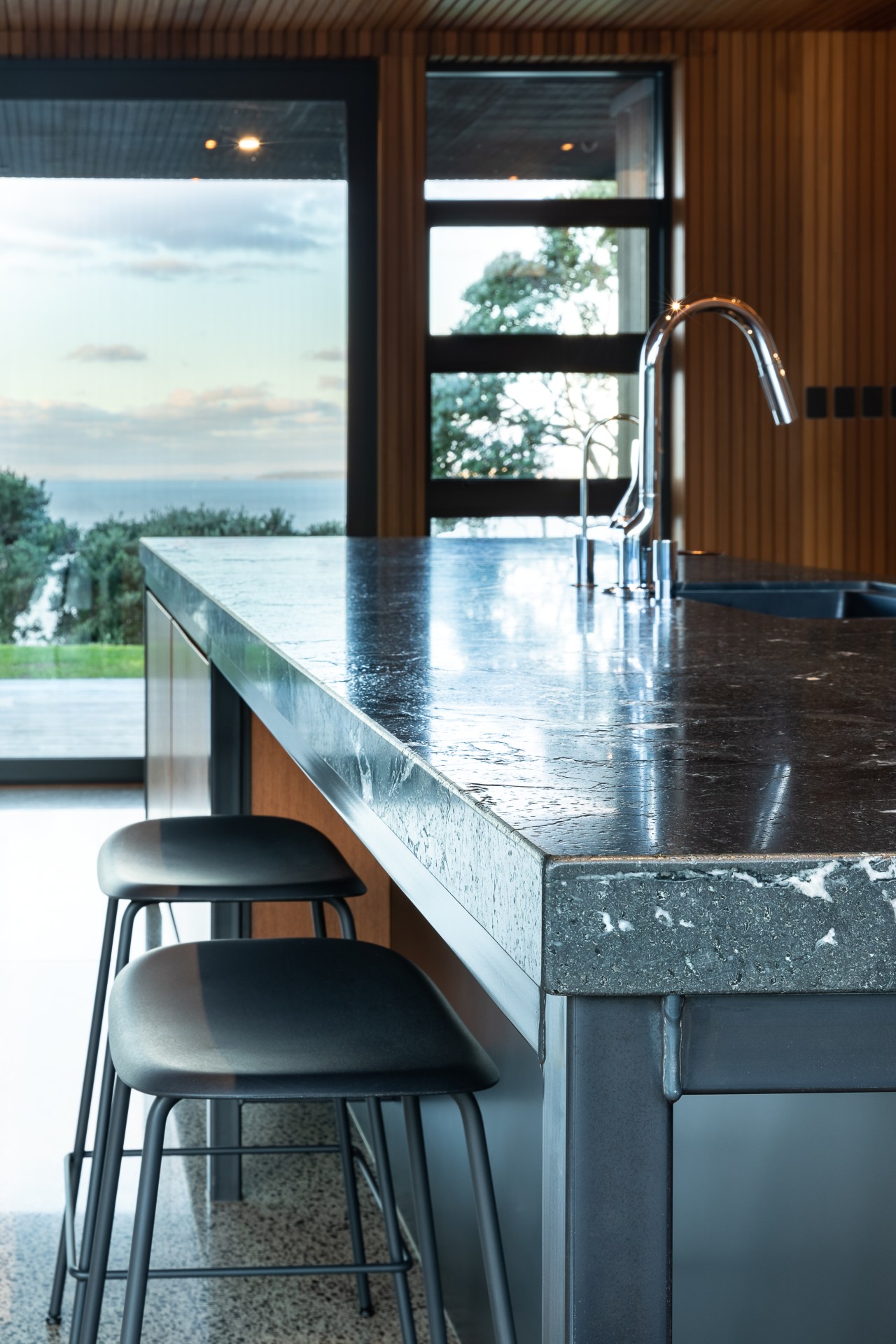 ​​​​​​​The leathered granite island benchtop adds textural interest architecture, building, cabinetry, countertop, floor, flooring, furniture, glass, granite, home, house, interior design, kitchen, marble, material property, property, room, table, tile, window, white, black