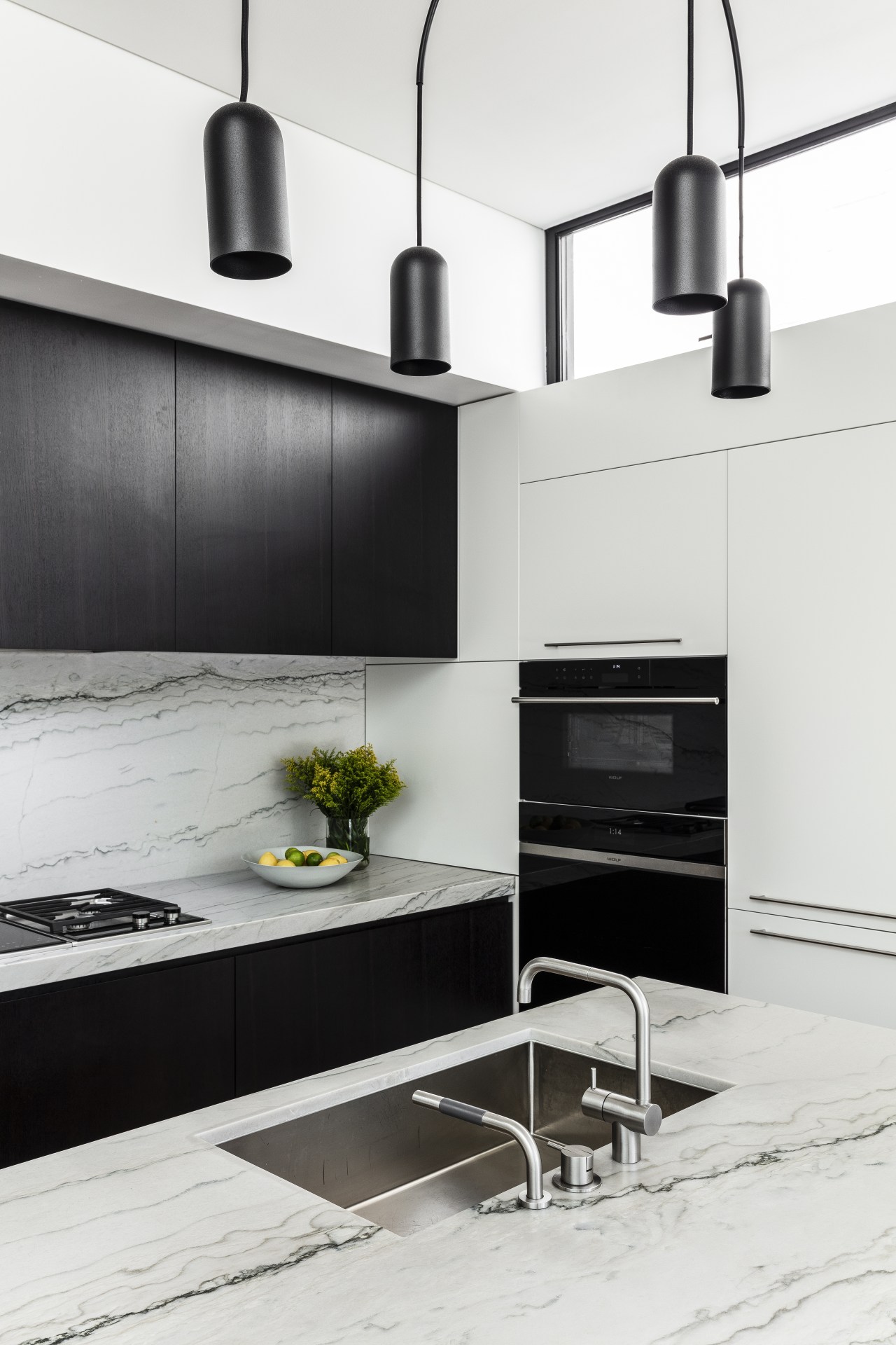 ​​​​​​​This kitchen’s minimalist lines connect with the wider white