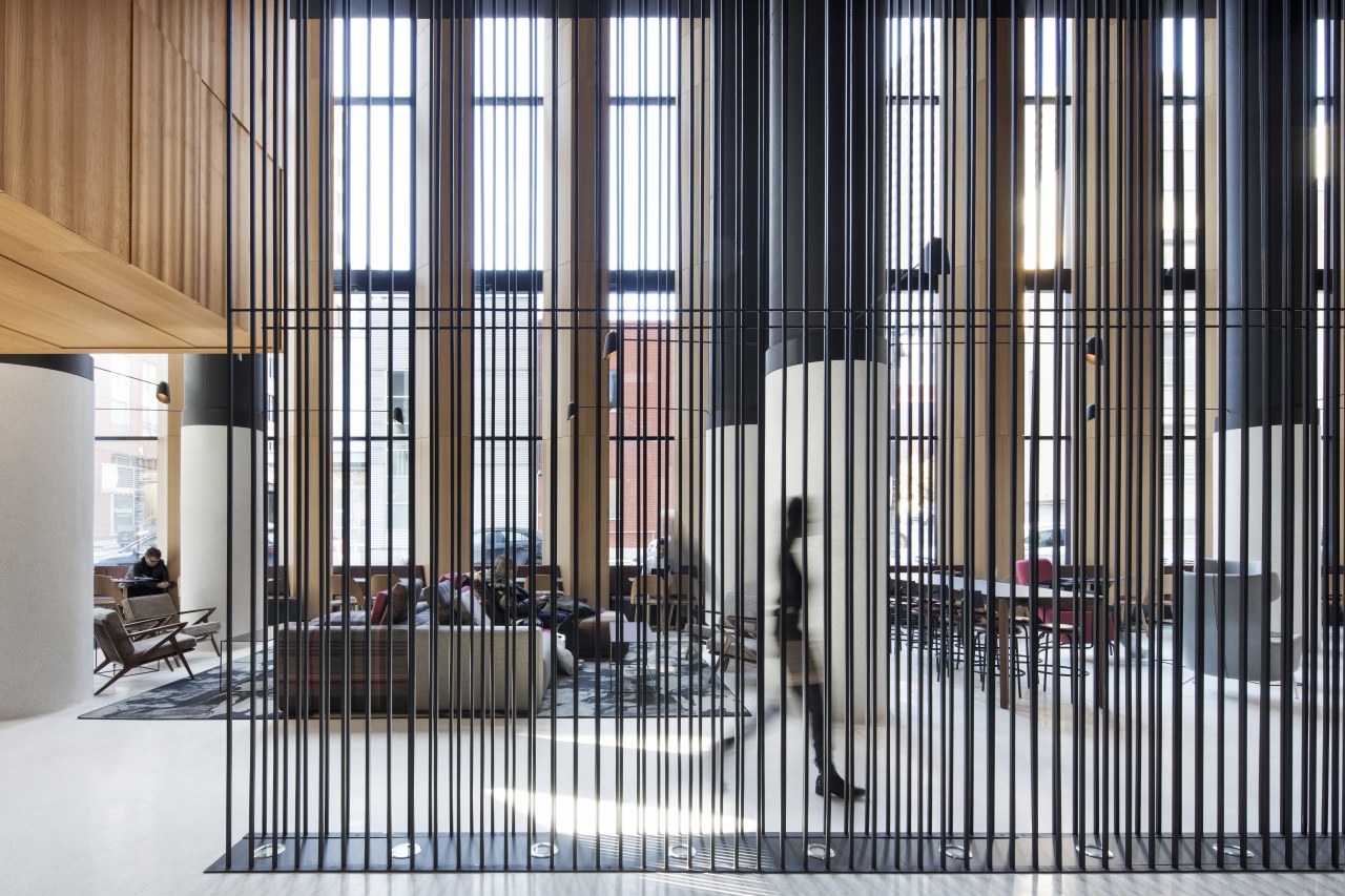 Slender suspended rods provide a transparent divider within architecture, building, Hotel Monville, Montreal Canada, divider, multi-use hotel lobby, suspended rods