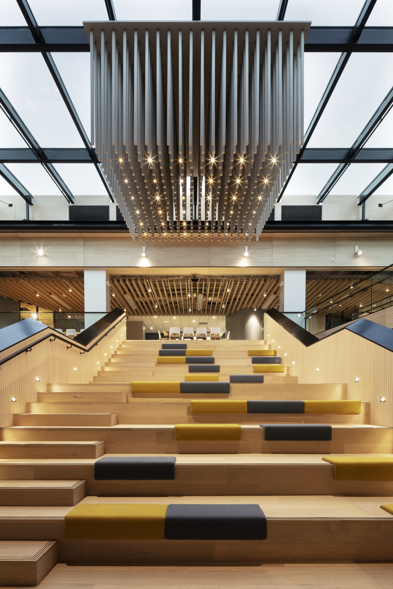 The grandstand stair in the Mercury offices fit-out Mercury, Warren and Mahoney, architecture, building, interior design, lighting, lobby, stairs, wood, brown