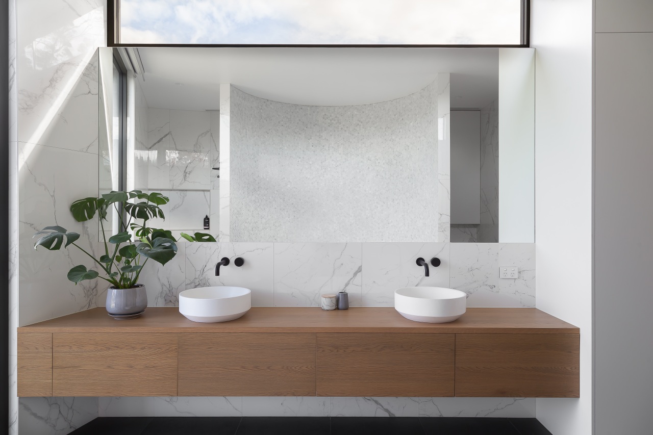 Floating the vanity in this contemporary master bathroom white, gray