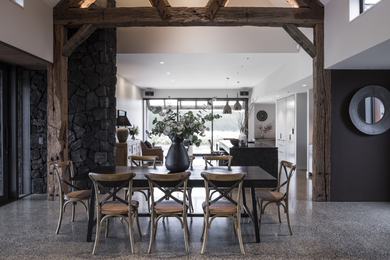 The dining area with rustic beams overhead. 