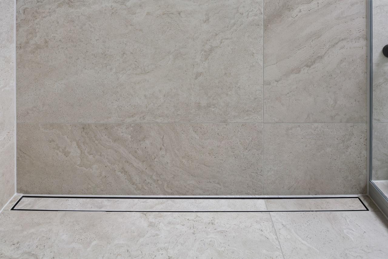 Matching channel drain in new shower. - Compact 