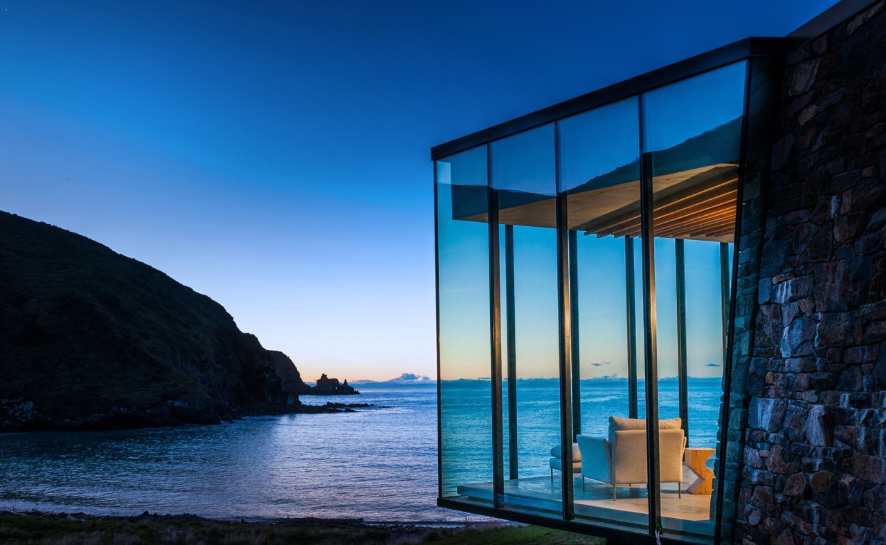 One of the newest additions to the luxury architecture, azure, blue, building, evening, glass, horizon, house, ocean, rock, room, sea, sky, water, window, black, blue