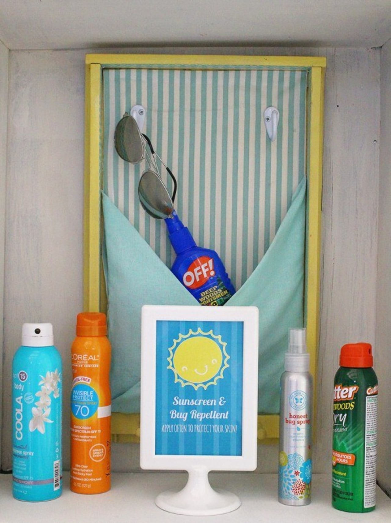 A sunblock and bug spray station product, shelf, gray