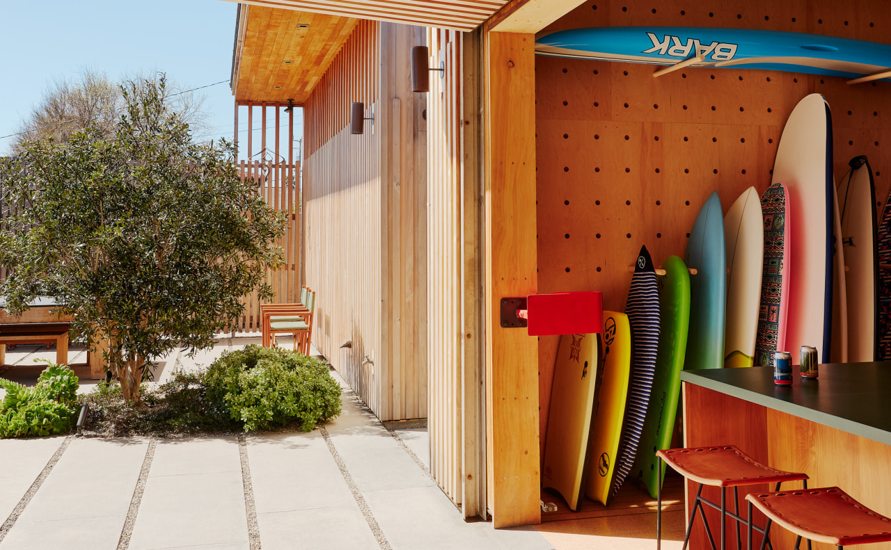 A customised surfboard storage unit and garage provide 