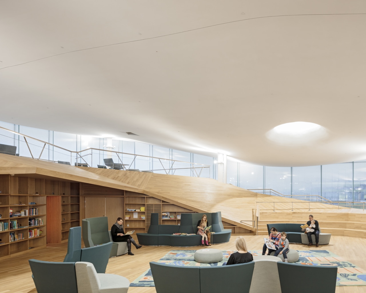 The library building is extremely energy efficient, with architecture, building, ceiling, daylighting, design, floor, flooring, furniture, home, house, interior design, living room, real estate, roof, room, shade, table, gray