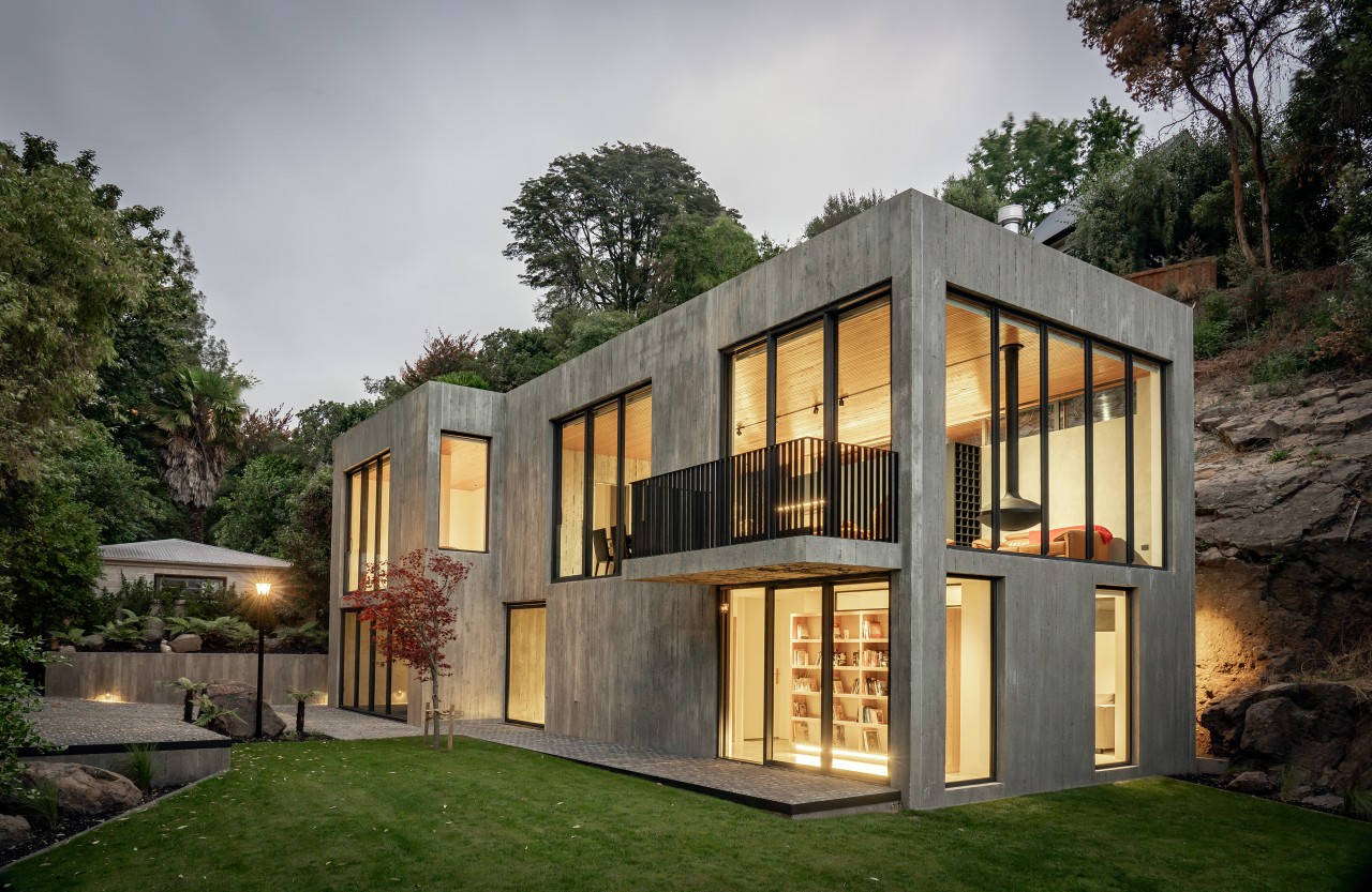 At night, the substantial glazing turns the home 