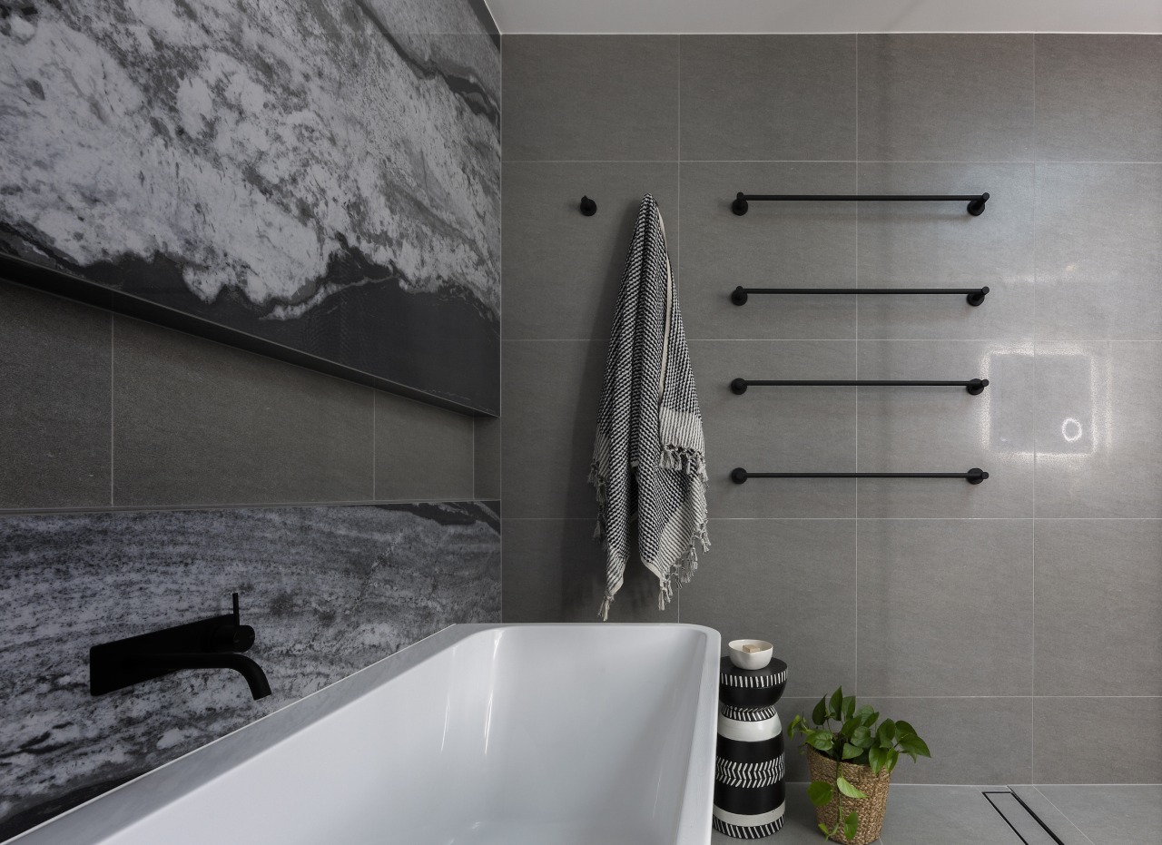 The bathroom's feature porcelain sheet, stone-look back wall 