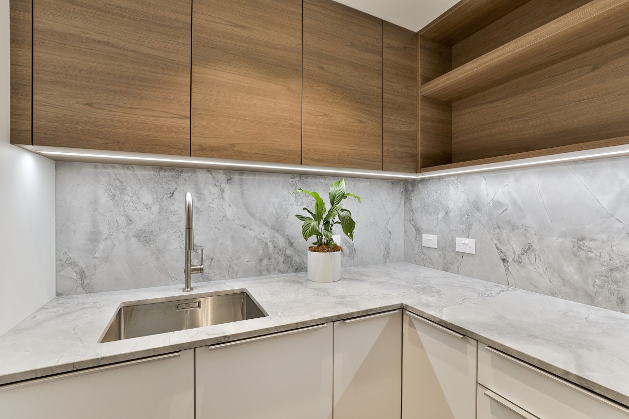 The capacious scullery features open wood display shelving 