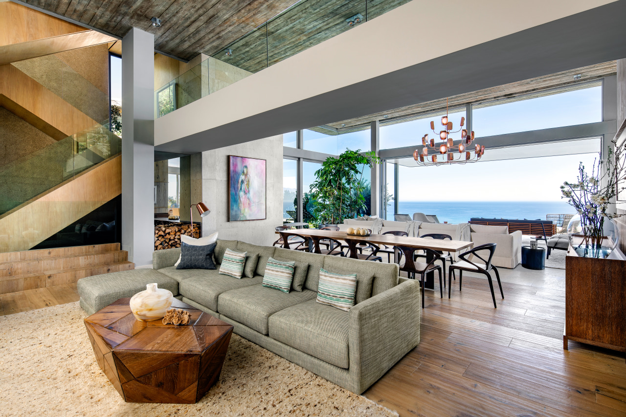 The living level is set back considerably to apartment, architecture, building, ceiling, coffee table, couch, estate, floor, flooring, furniture, hardwood, home, house, interior design, laminate flooring, living room, loft, property, real estate, roof, room, table, wall, wood, wood flooring, gray