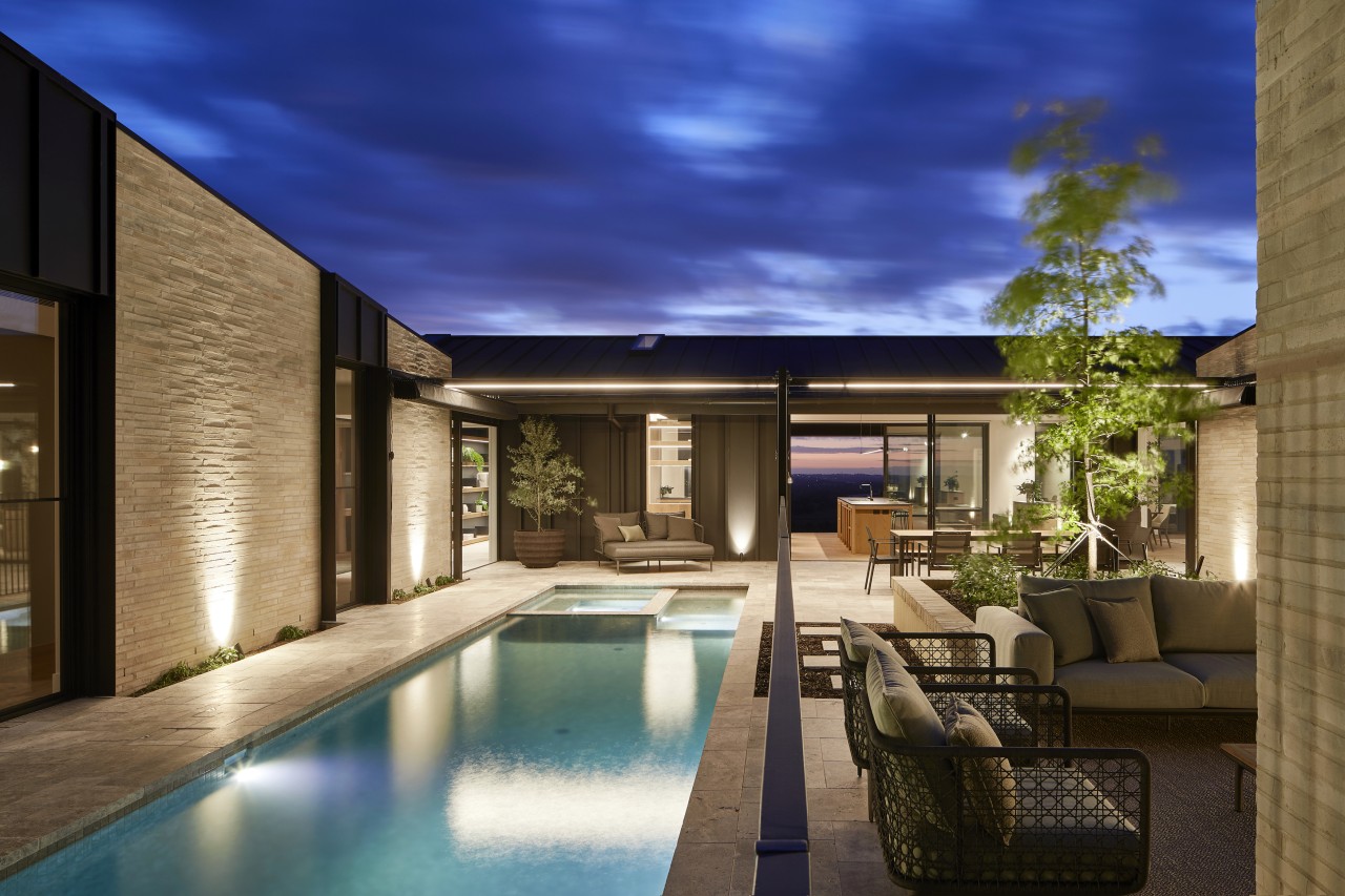 Up lighting accentuates the textural hand-made brickwork cladding. 