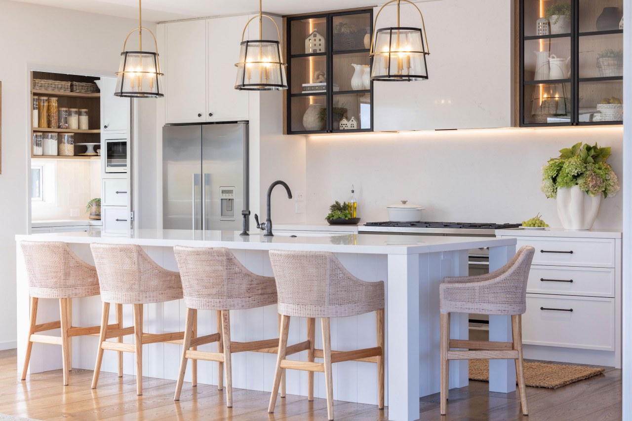 The kitchen boasts predominantly pale, refined tones. 