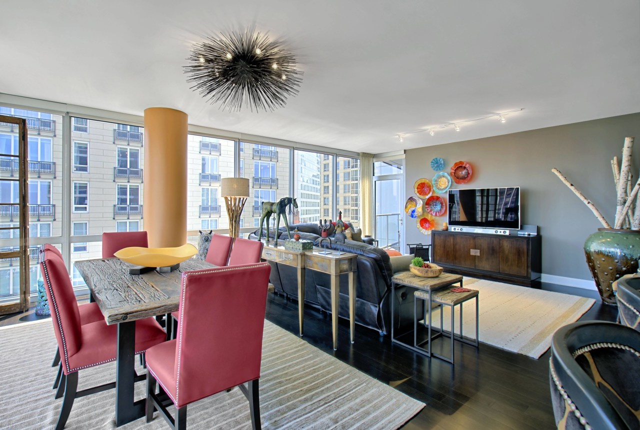 These bright-red, faux-leather chairs paired with a warm, apartment, dining room, home, interior design, living room, property, real estate, room, table, gray