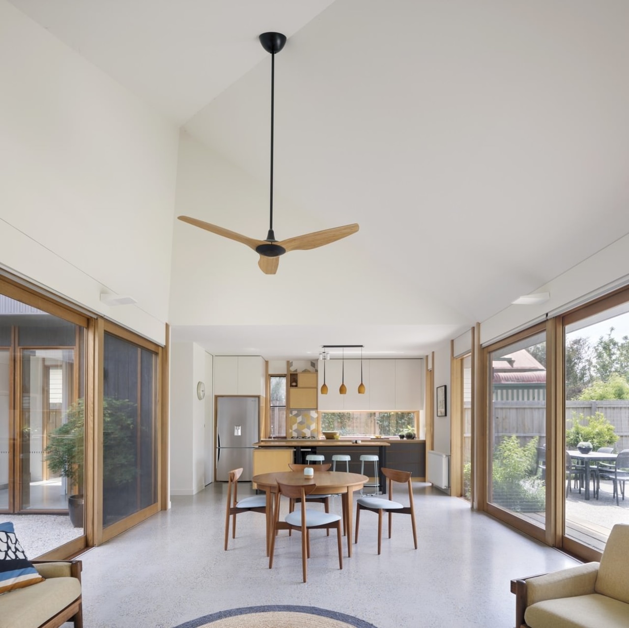 The large ceiling fan draws the eye in architecture, ceiling, ceiling fan, daylighting, estate, home, house, interior design, lighting, living room, property, real estate, window, gray