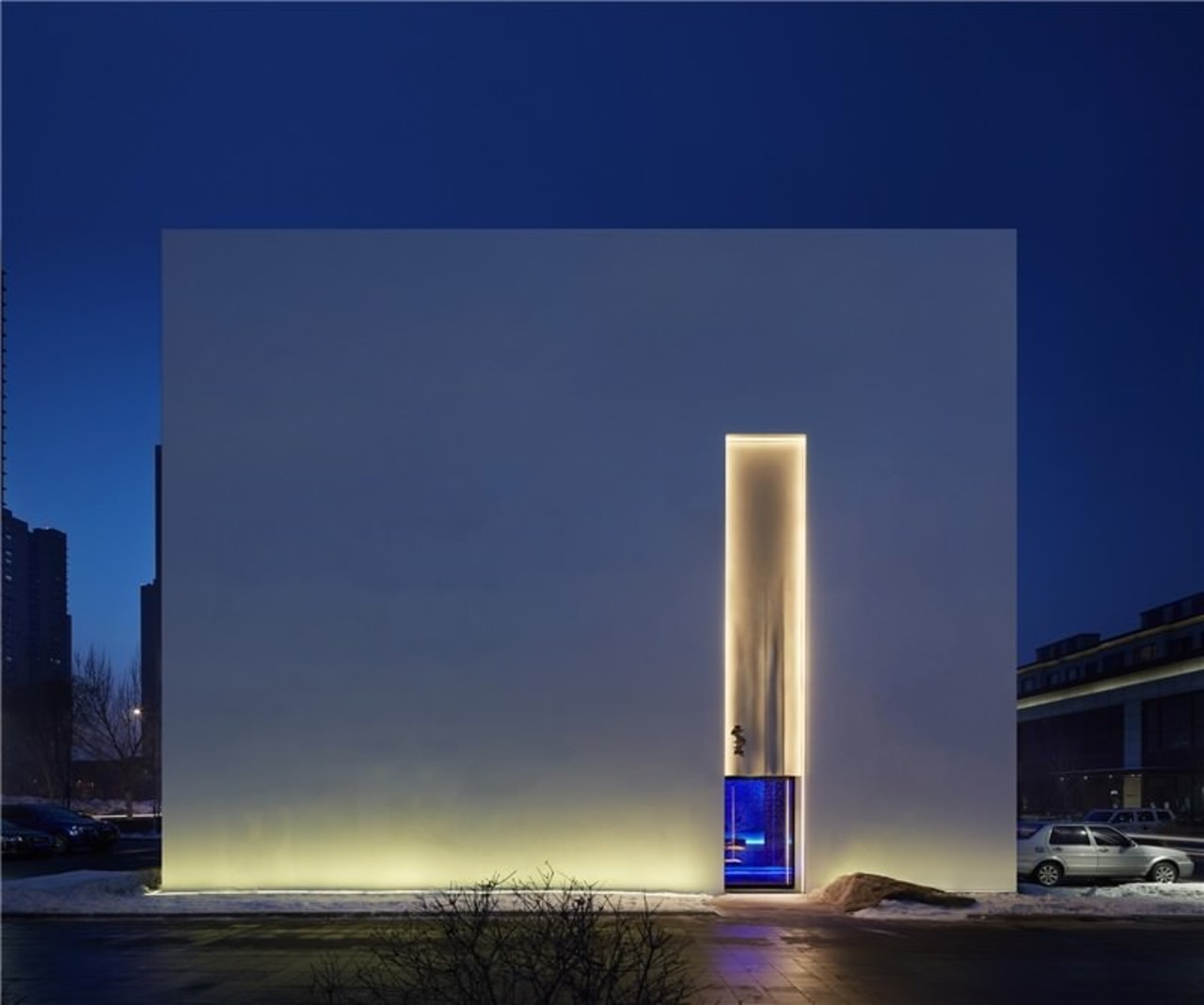 Your is immediately drawn to the glowing entrance architecture, atmosphere, building, corporate headquarters, daytime, reflection, sky, skyscraper, tower, tower block, blue