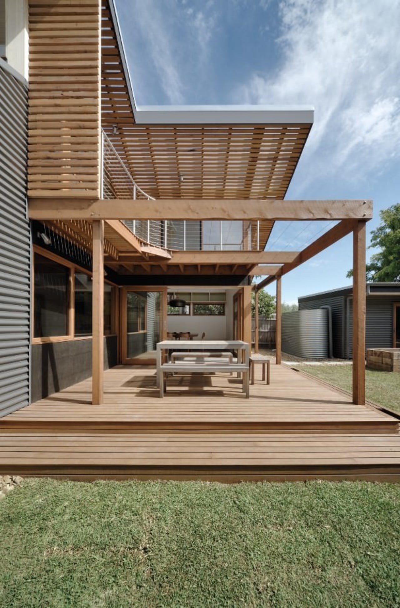 Wood slats line the upper level of this architecture, deck, elevation, facade, house, outdoor structure, real estate, residential area, siding, brown