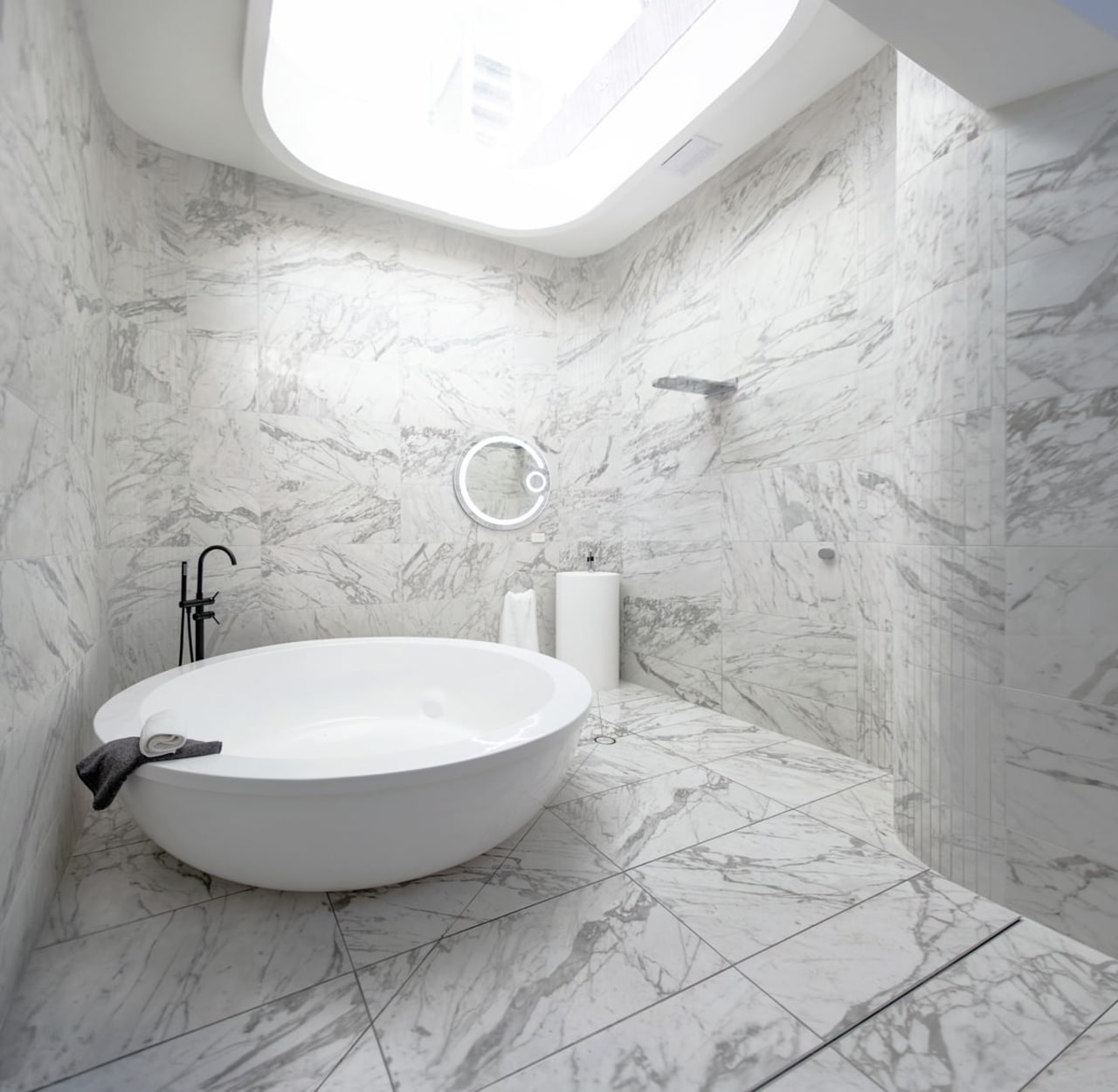 Marble runs across the floor – and up bathroom, bathroom sink, bidet, ceramic, floor, flooring, interior design, plumbing fixture, product design, room, sink, tap, tile, toilet seat, wall, gray, white