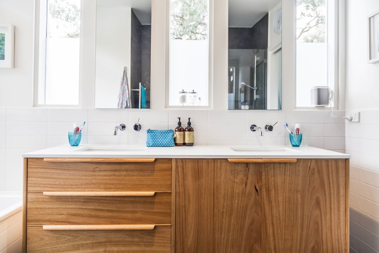 A wood vanity adds an element of colour bathroom, bathroom accessory, bathroom cabinet, cabinetry, countertop, interior design, kitchen, product design, room, sink, white