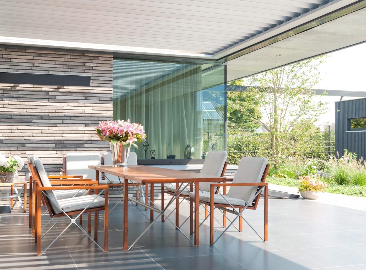 Outdoor room featuring a louvre by Louvretec backyard, chair, daylighting, deck, house, interior design, outdoor furniture, outdoor structure, patio, real estate, roof, table, window, white