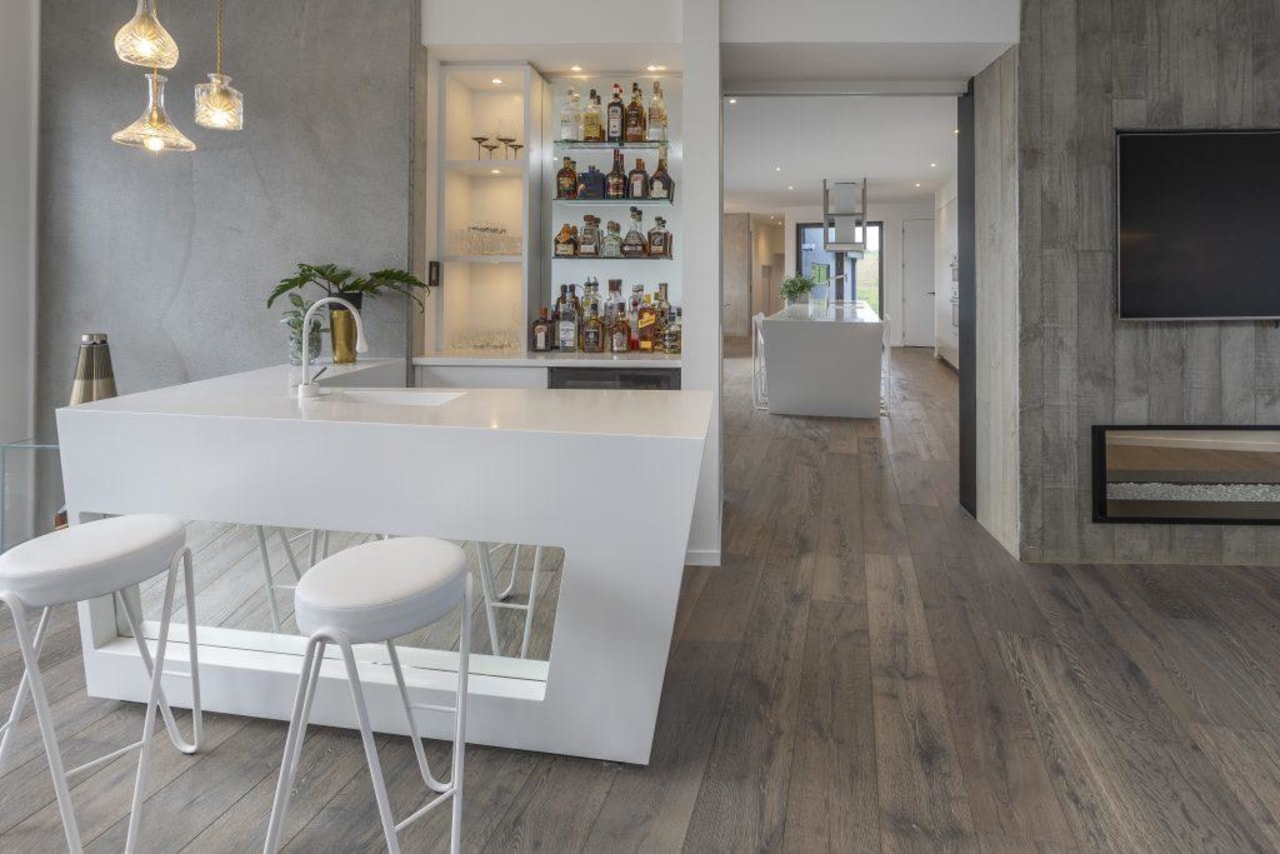 A view of the winning bar, which connects dining room, floor, flooring, furniture, hardwood, interior design, laminate flooring, table, tile, wall, wood flooring, gray
