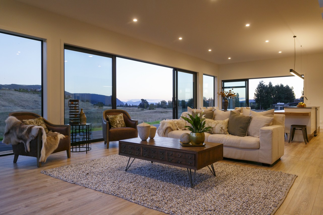 ​​​​​​​Over-sized tinted sliders make the interior of this apartment, architecture, building, ceiling, coffee table, design, door, estate, floor, flooring, furniture, home, house, interior design, living room, property, real estate, room, table, wall, window, gray