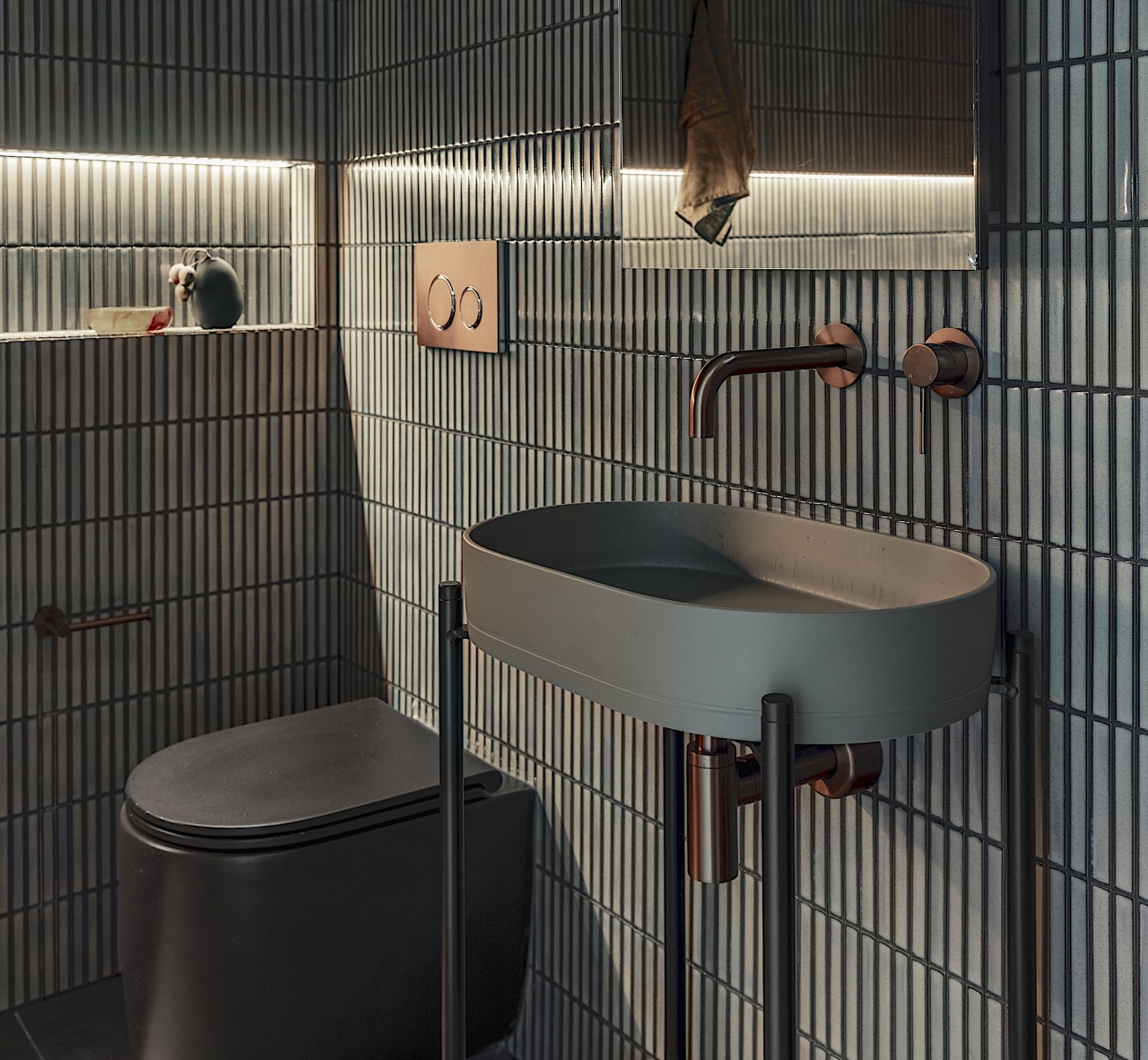 Bronze tapware, integrated lighting and a sculptural basin 
