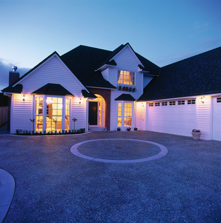 A photograph of a two storey house featuring architecture, building, cottage, estate, evening, facade, home, house, landscape lighting, lighting, property, real estate, residential area, roof, shed, siding, sky, suburb, window, blue