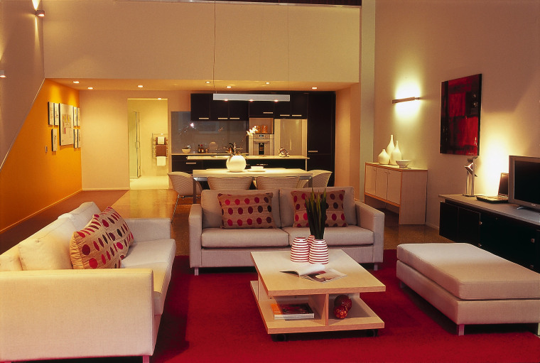 A lounge area featuring sofas, dotted cushions, a ceiling, furniture, interior design, living room, property, real estate, room, suite, orange, brown