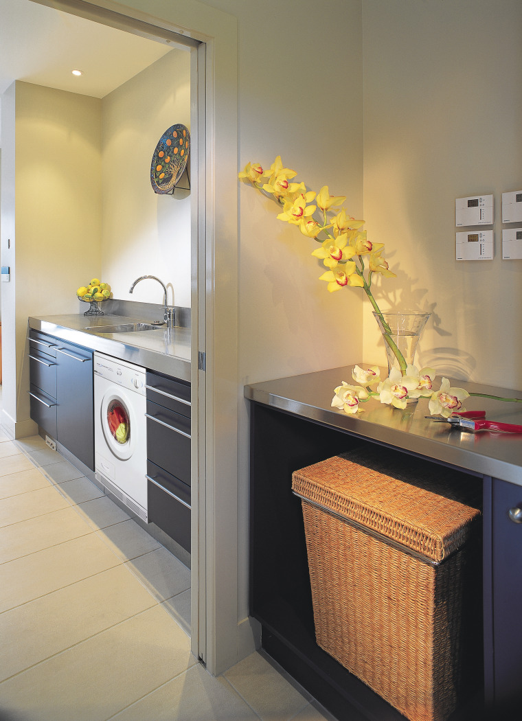 A laundry featuring a Smeg dryer. The laundry countertop, home appliance, interior design, kitchen, major appliance, room, gray, orange