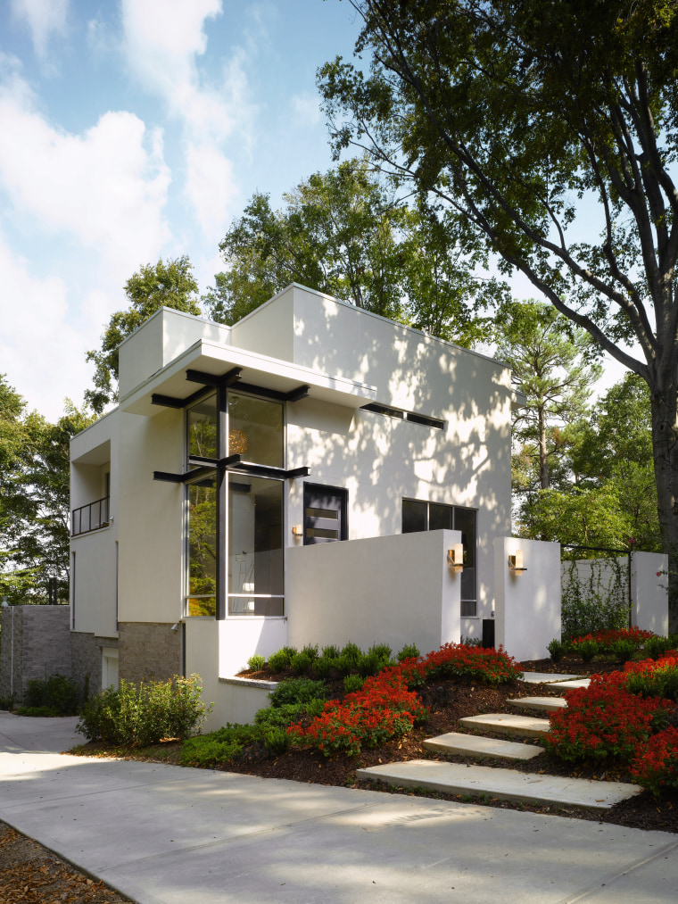 An exterior view of the entrance way to architecture, cottage, elevation, facade, home, house, neighbourhood, property, real estate, residential area, white, gray, brown