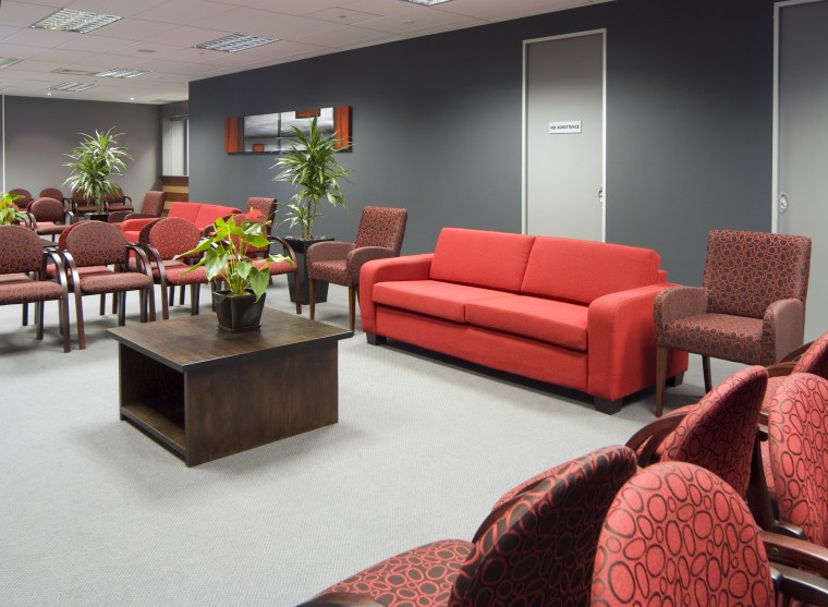 Vibrant red and gray furnishings enliven the couch, furniture, interior design, living room, loveseat, room, table, waiting room, red, gray