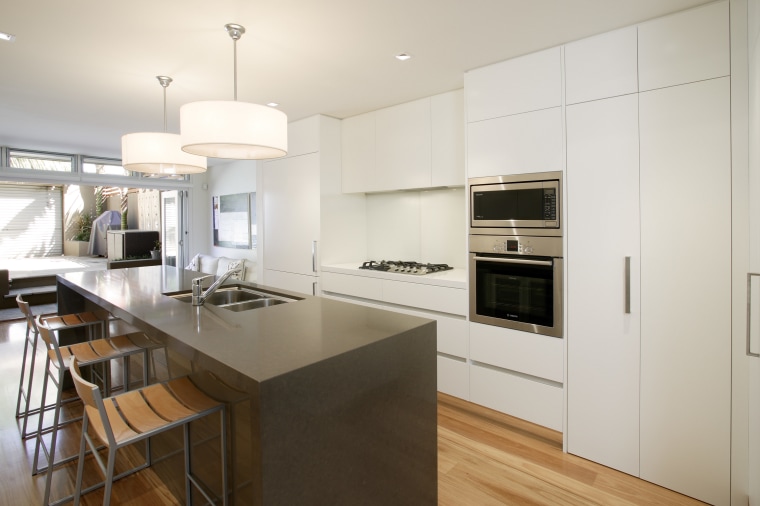 View of a narrow kitchen designed by Wonderful cabinetry, countertop, cuisine classique, floor, interior design, kitchen, real estate, wood flooring, white