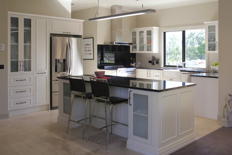 View of a kitchen designed and manufactured by cabinetry, countertop, cuisine classique, desk, floor, furniture, kitchen, room, gray