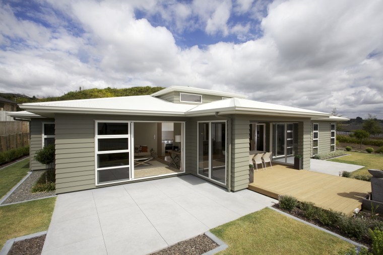 This Tauranga show home has several features with elevation, estate, facade, home, house, property, real estate, residential area, roof, gray