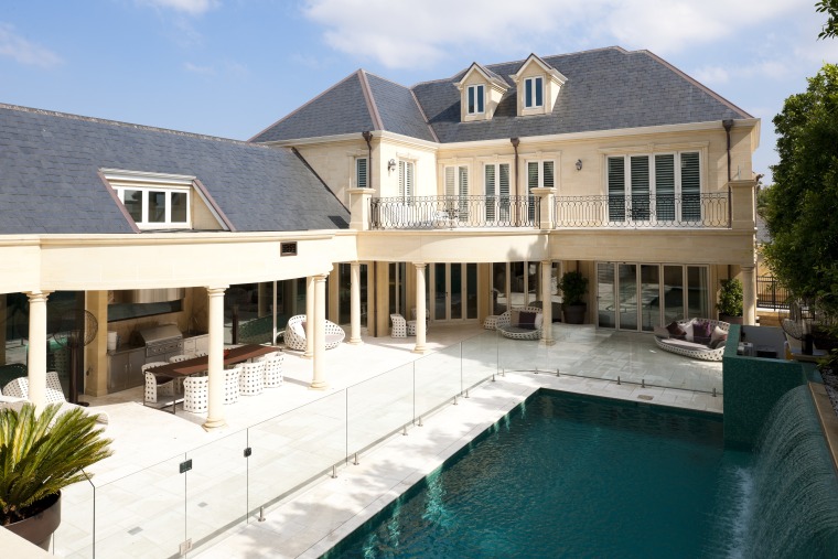 This European-style house has an Italianate look at elevation, estate, facade, home, house, mansion, property, real estate, residential area, swimming pool, villa, window, white