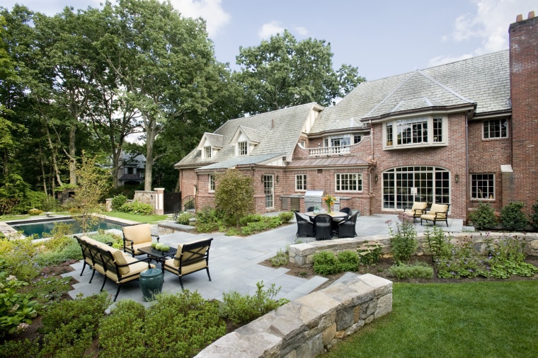 An extensive remodeling project has transformed this 1920s backyard, cottage, courtyard, estate, farmhouse, garden, home, house, landscape, landscaping, outdoor structure, property, real estate, yard