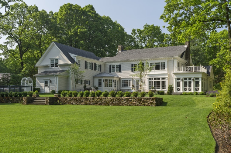 This L-shaped New England Colonial house wraps around backyard, cottage, elevation, estate, facade, farmhouse, grass, historic house, home, house, land lot, landscape, landscaping, lawn, mansion, plantation, property, real estate, residential area, siding, yard, green