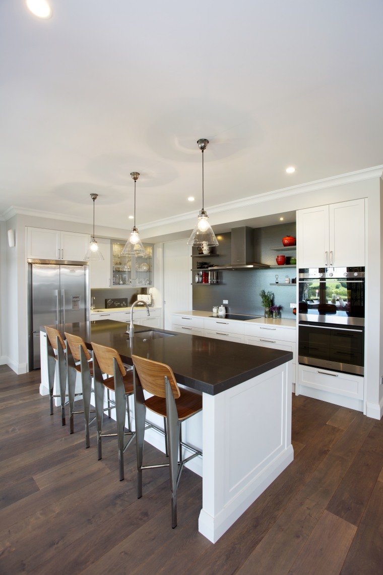 A dark splashback, charcoal grey island benchtop countertop, cuisine classique, floor, flooring, interior design, kitchen, real estate, room, wood flooring, gray